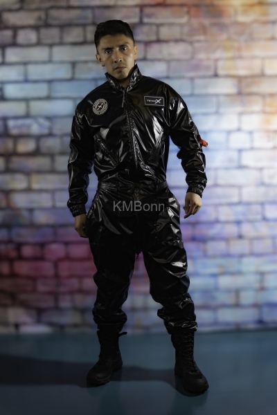 andyscorpiox poses in glossy TwinkX PVC flight suit at Grabbys 2026