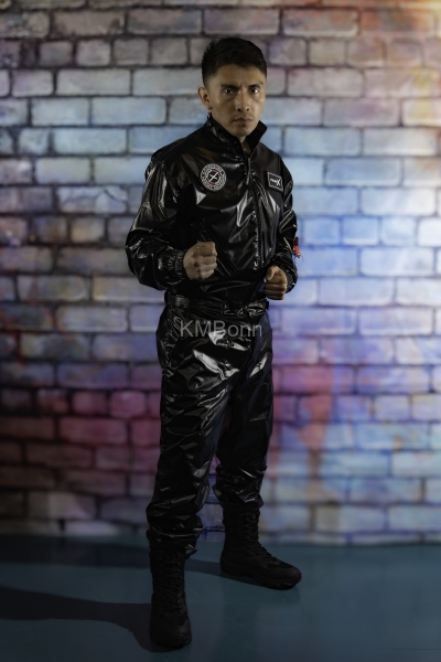 andyscorpiox poses in glossy TwinkX PVC flight suit at Grabbys 2026