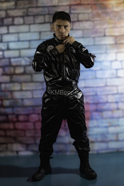 andyscorpiox poses in glossy TwinkX PVC flight suit at Grabbys 2026