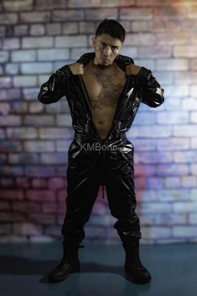 andyscorpiox poses in glossy TwinkX PVC flight suit at Grabbys 2026